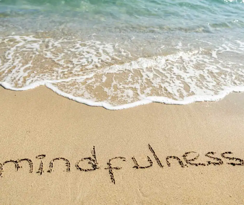 Mindfulness written into the sand